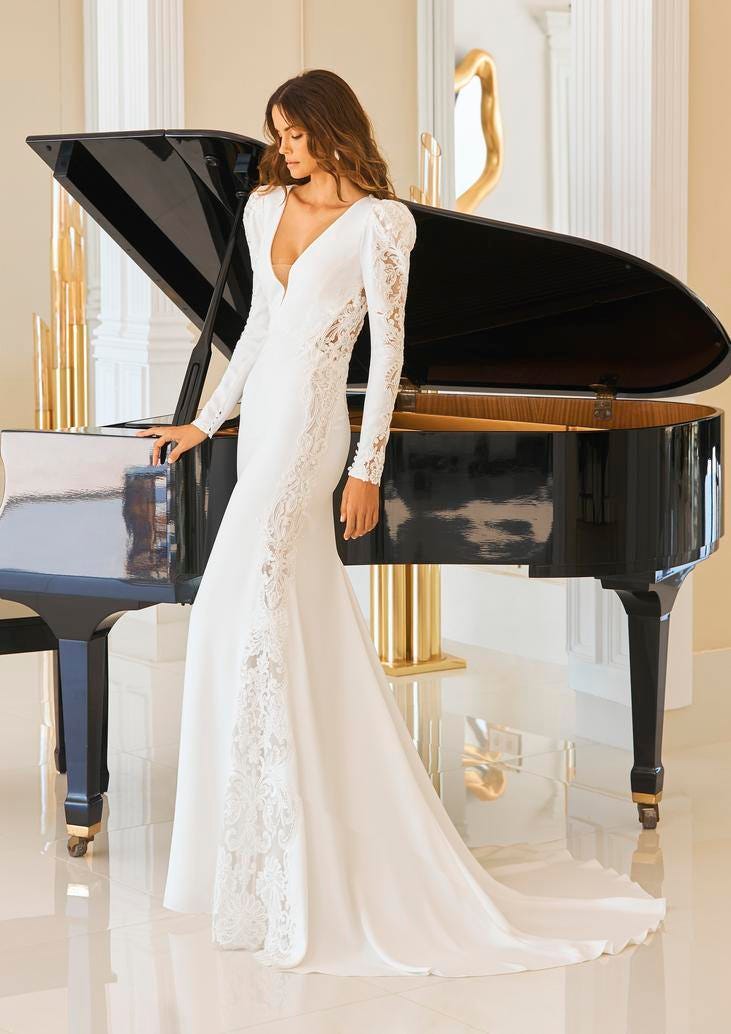 Panna młoda w długiej dopasowanej sukni ślubnej stojąca przy czarnym fortepianie